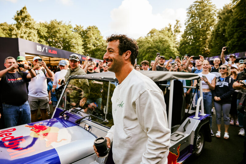 Daniel Ricciardo hopping out of a Red Bull MOKE